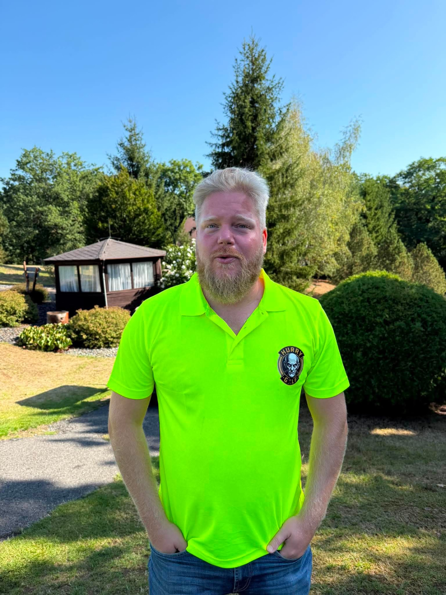 Golfer in a neon yellow HurryGolf polo shirt on the course