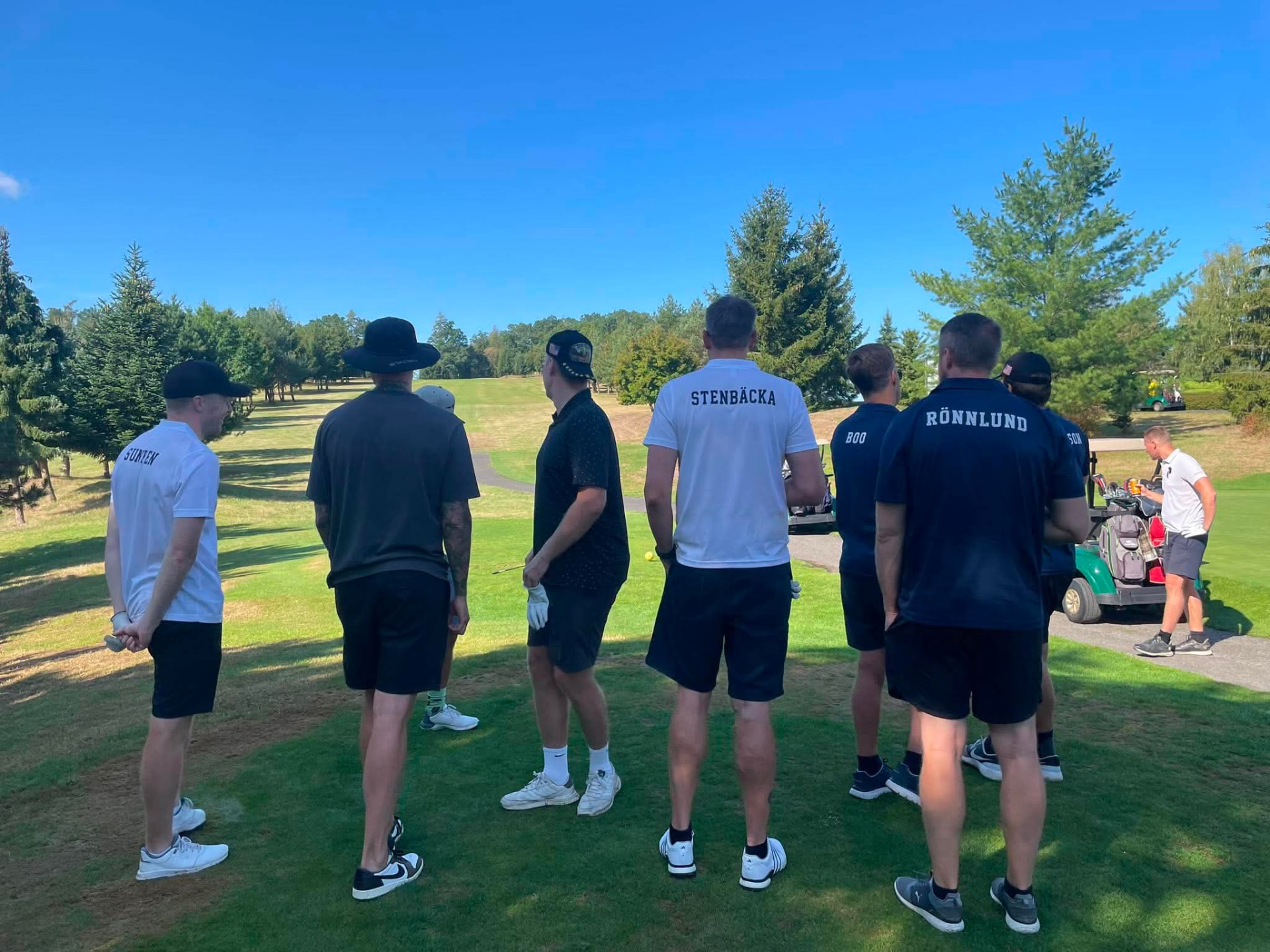 Golfers in matching HurryGolf team shirts on the tee box